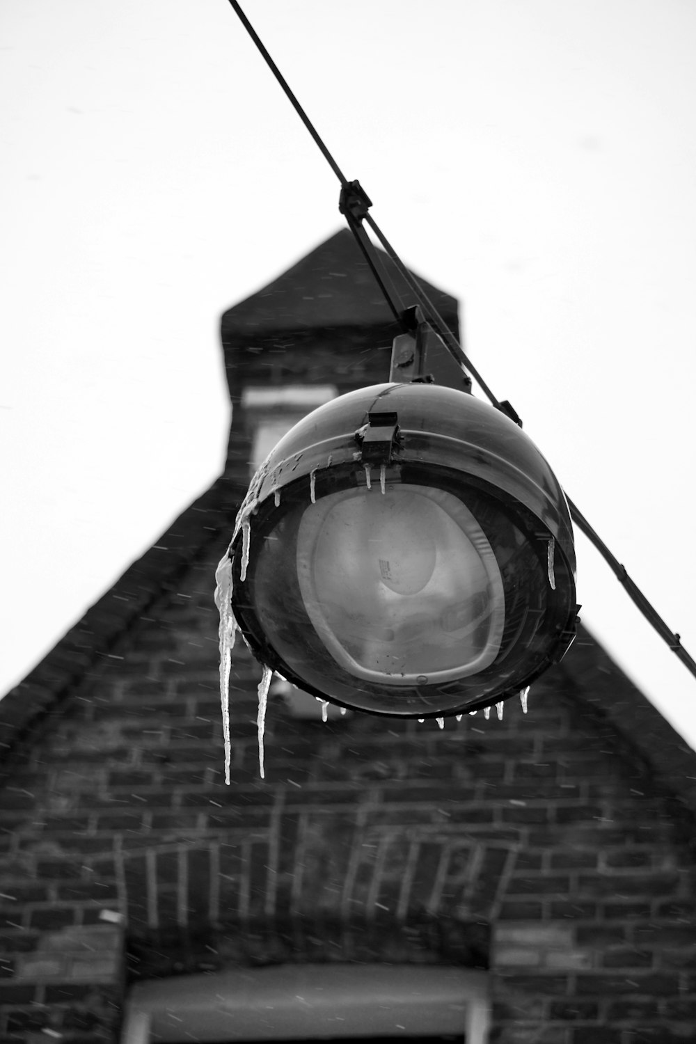 a street light with icicles hanging from it