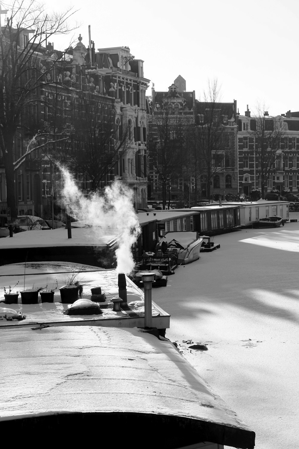 a black and white photo of a river with steam coming out of it