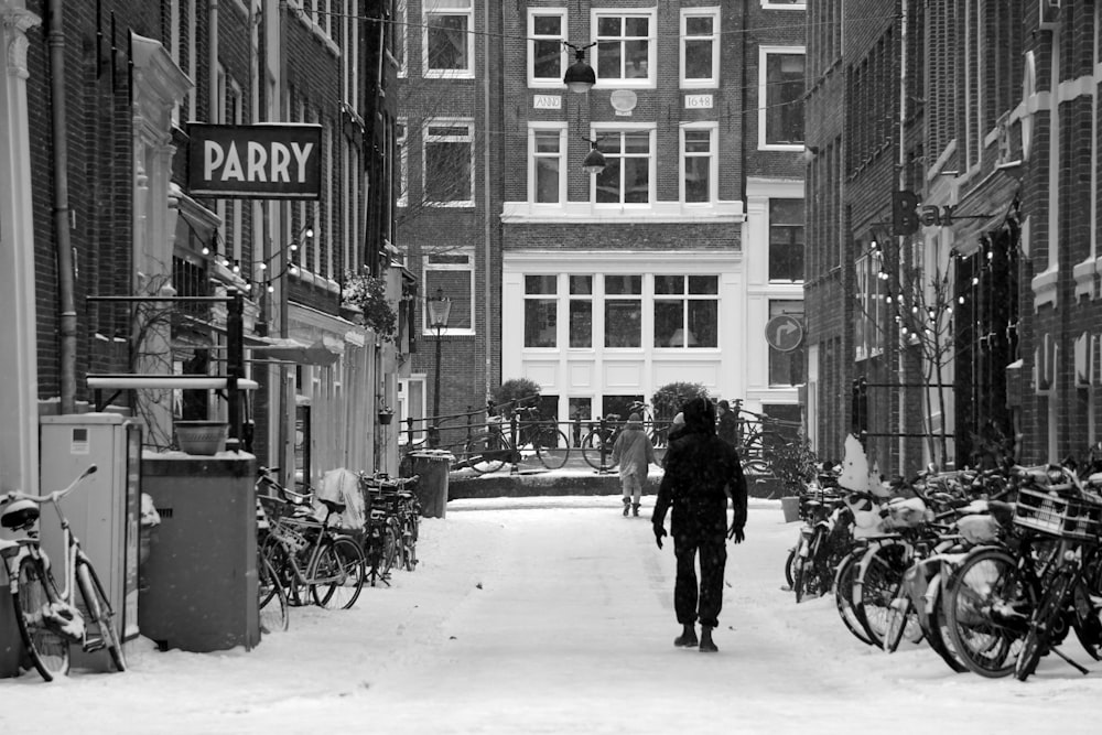 a person walking down a snow covered street