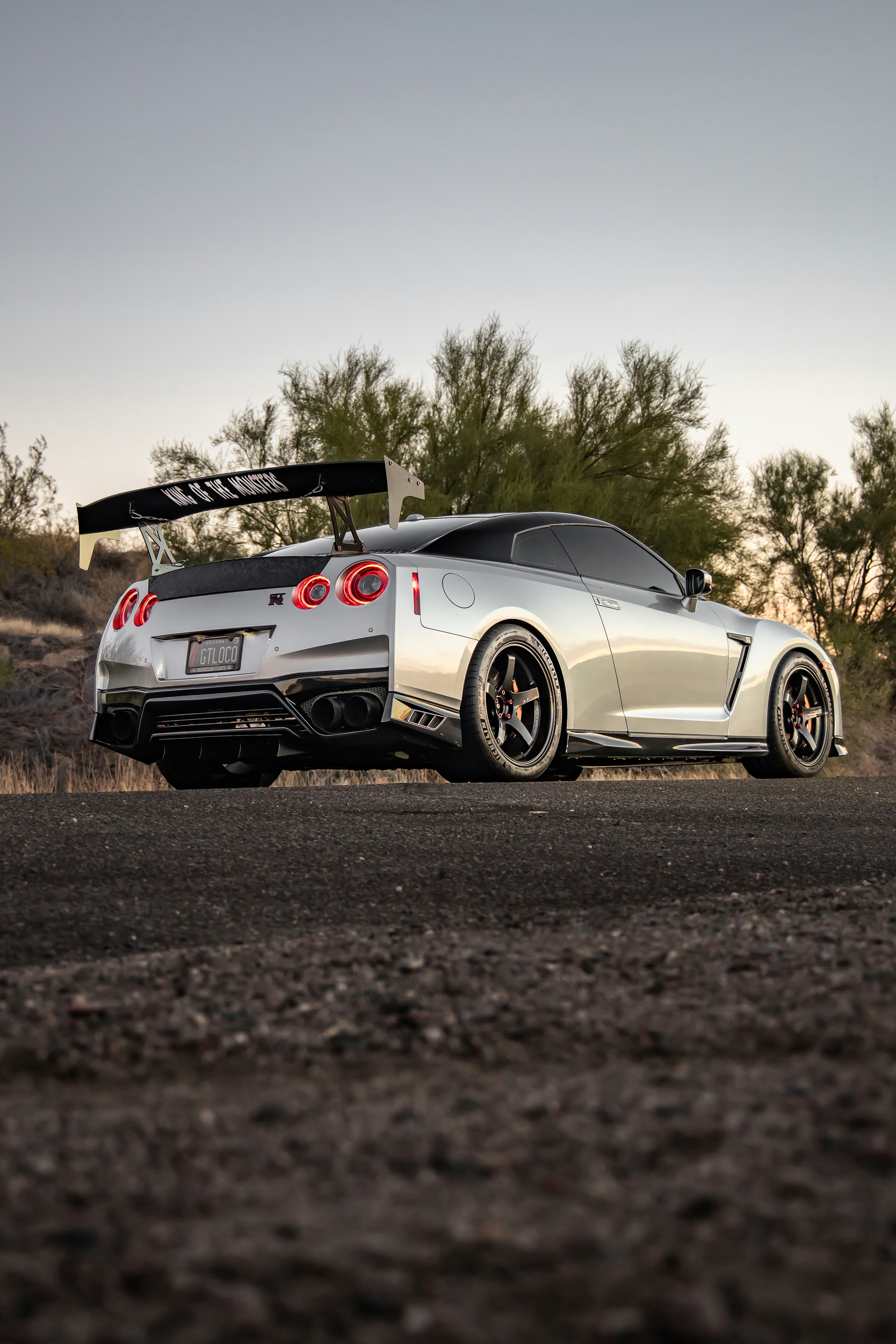 a white sports car parked on the side of the road