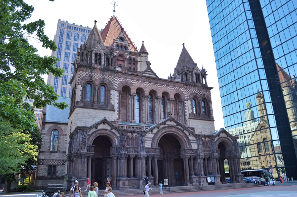 a group of people walking in front of a building