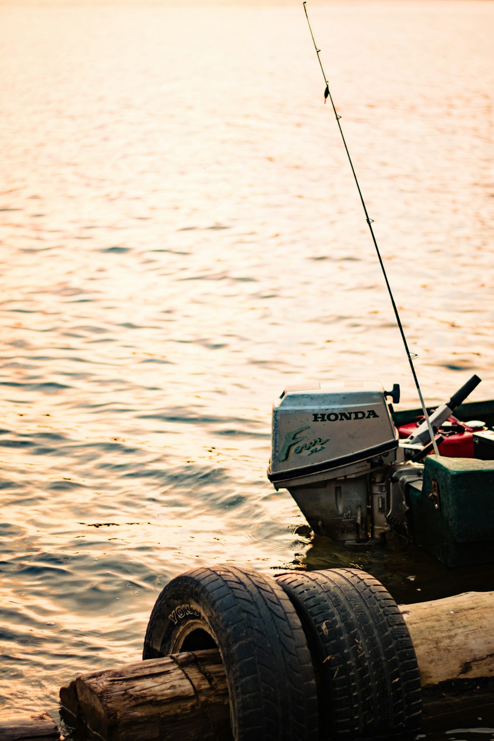 a small boat with a fishing rod attached to it