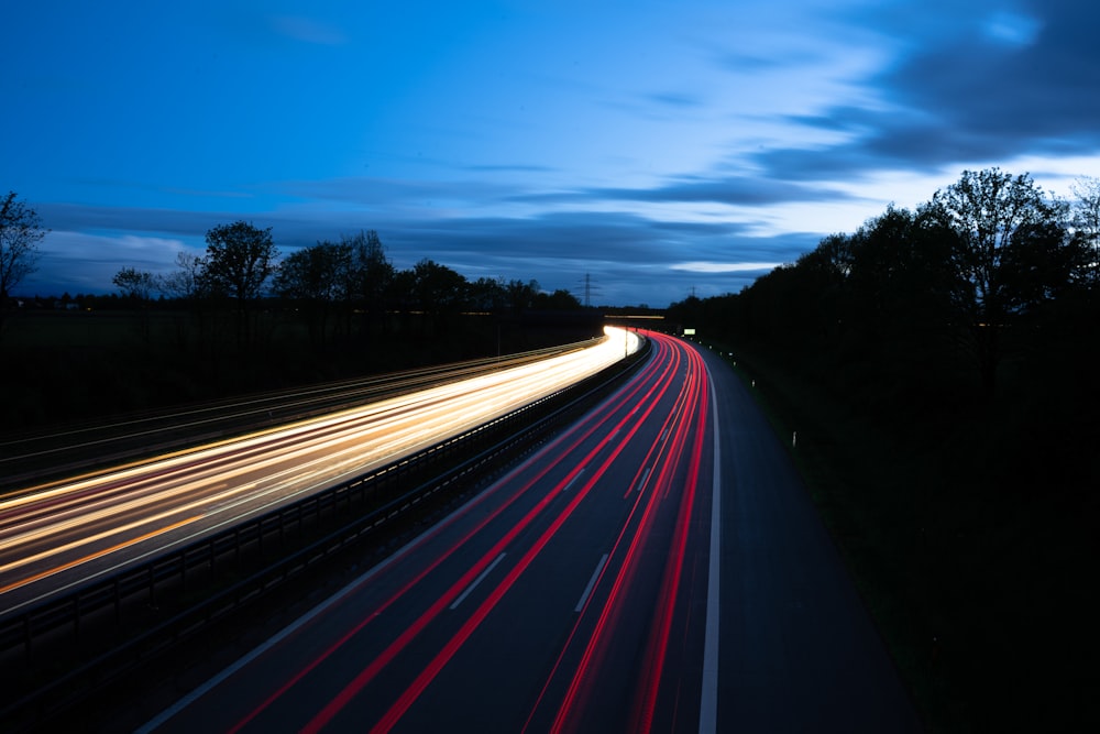 a long exposure photo of a highway at night