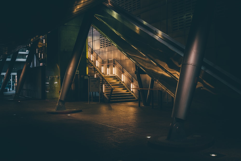 a building with stairs and lights at night