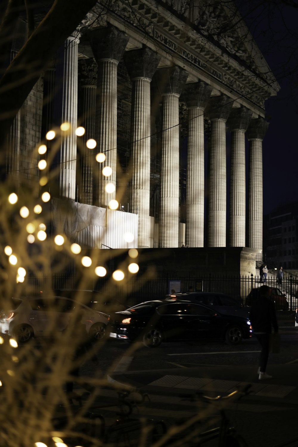 a building with columns and lights in front of it