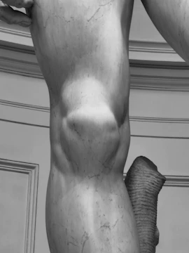 High-precision 3D scanner capturing the surface of an antique sculpture.