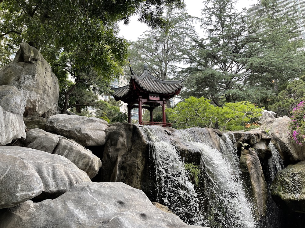 a waterfall with a pagoda in the middle of it