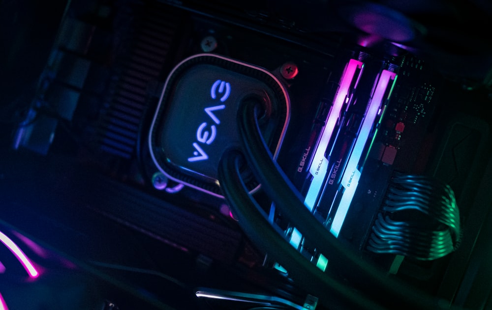 a close up of a computer and wires in a dark room