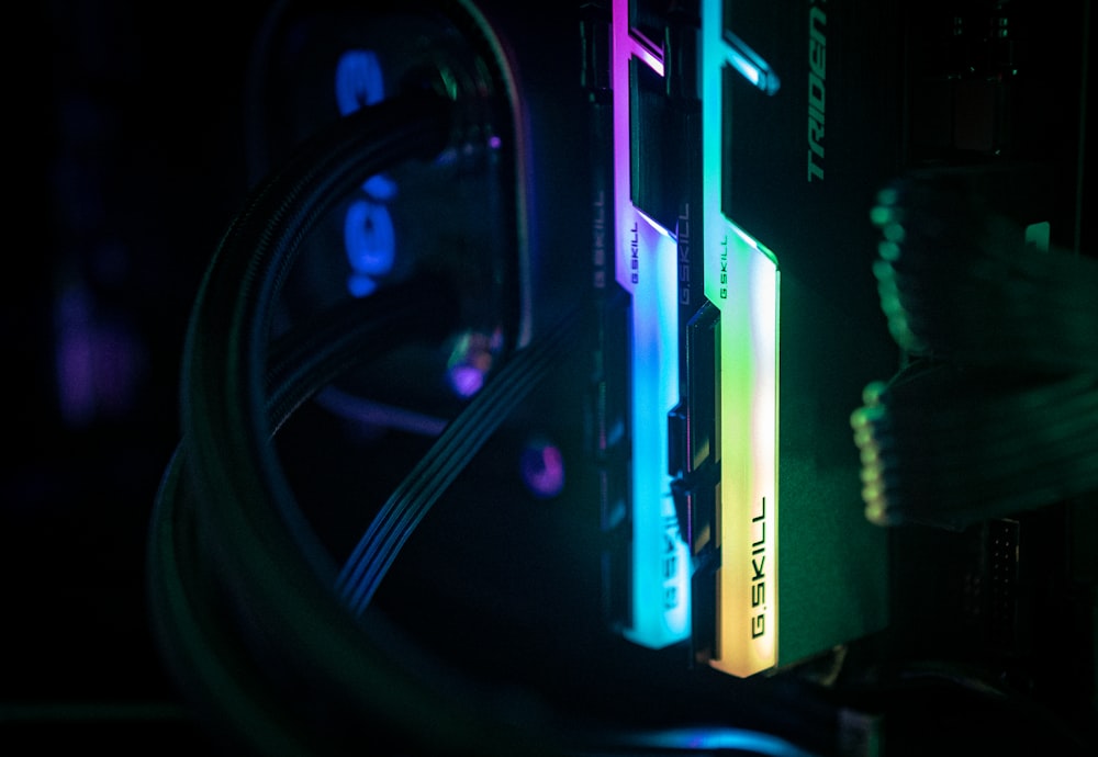 a close up of a computer and wires in a dark room