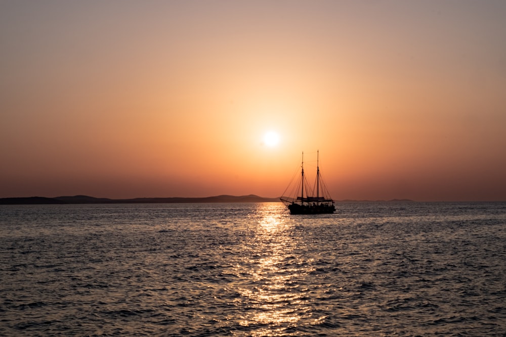 a boat floating on top of a large body of water