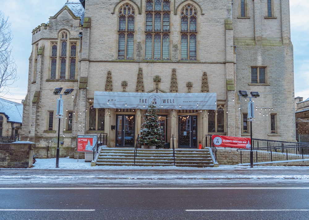 a large building with a christmas tree in front of it