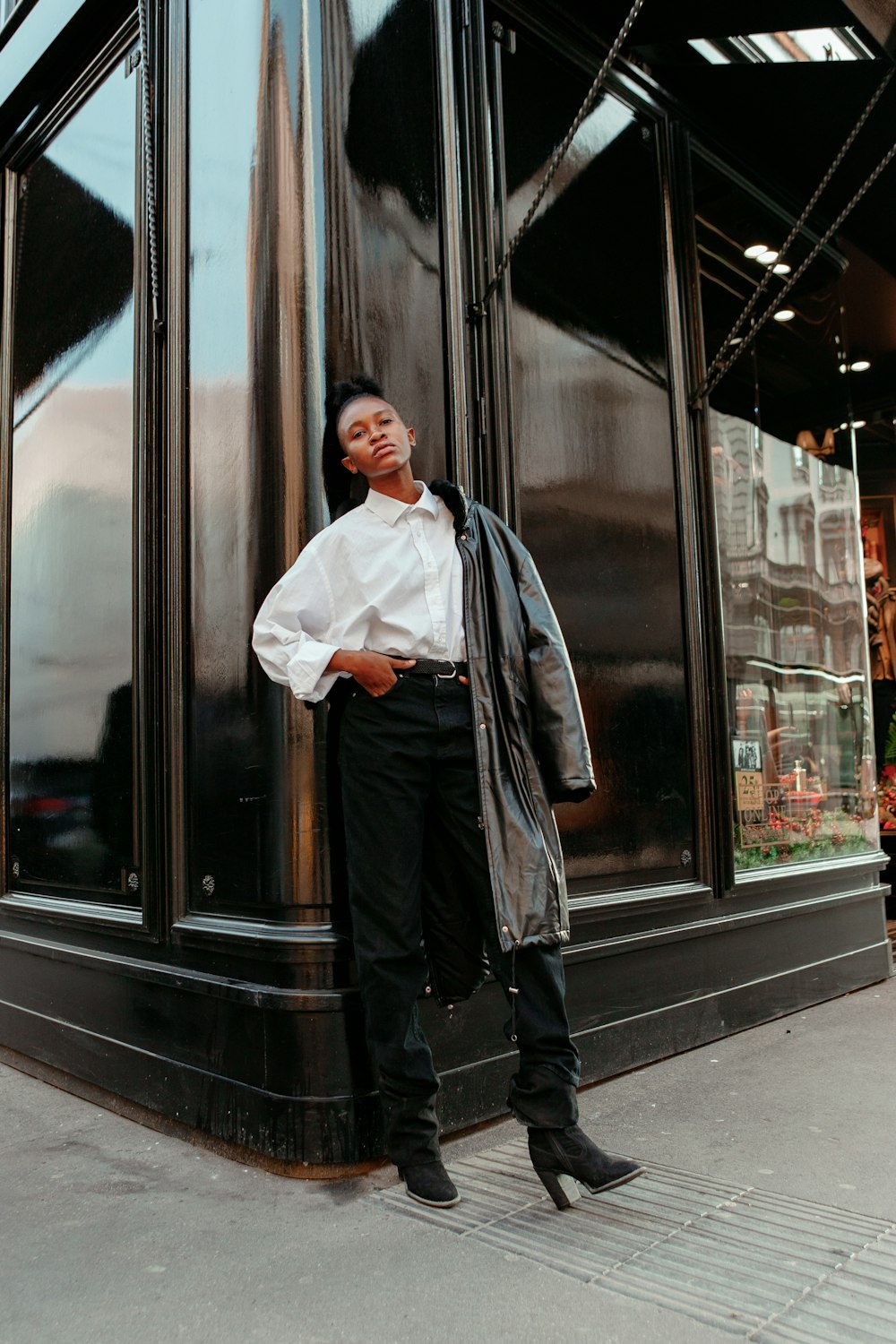 a man standing in front of a tall building