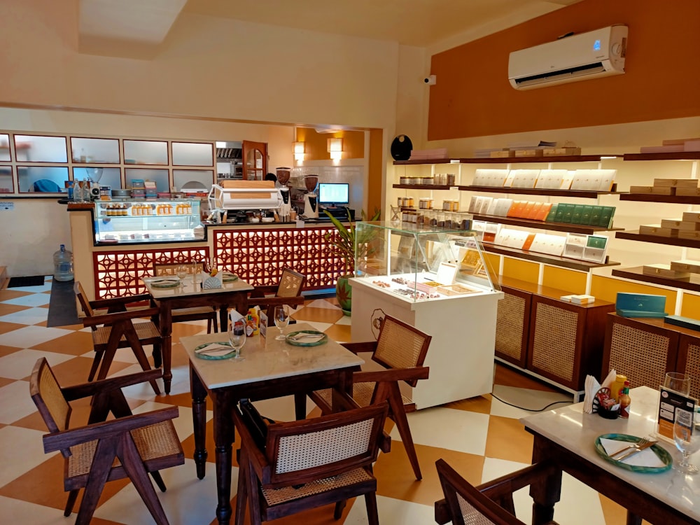 a restaurant filled with lots of tables and chairs