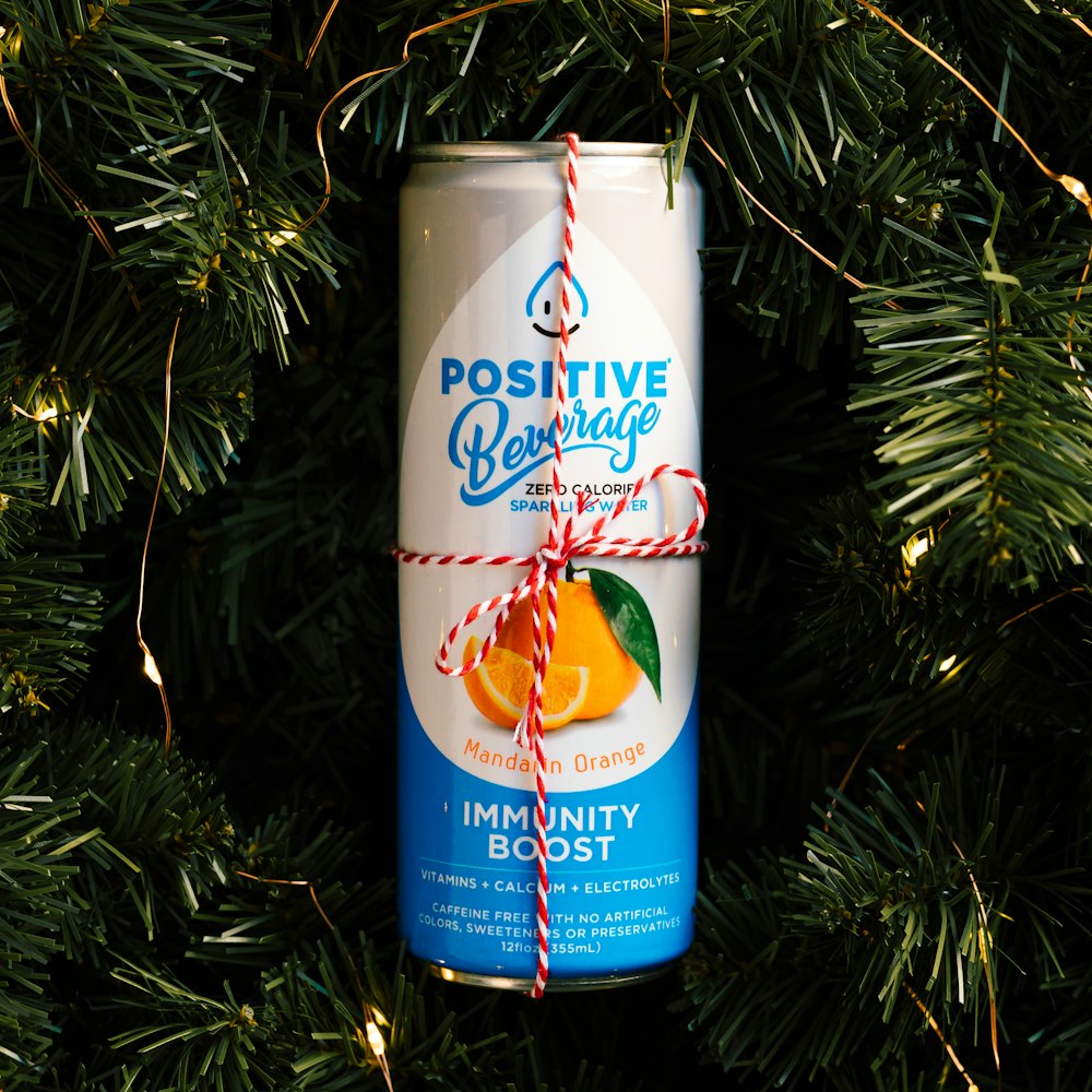 a can of orange juice hanging from a christmas tree