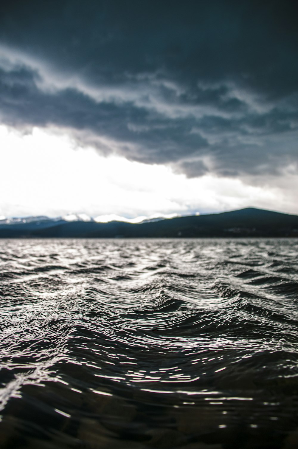 a body of water under a cloudy sky