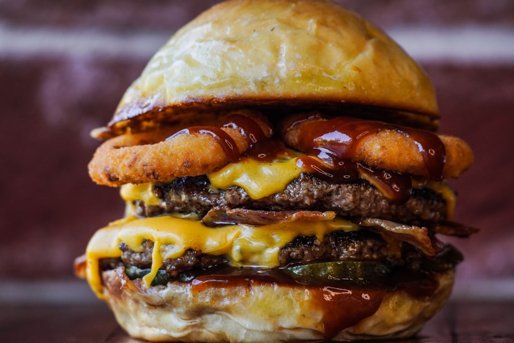a cheeseburger with onion rings and ketchup
