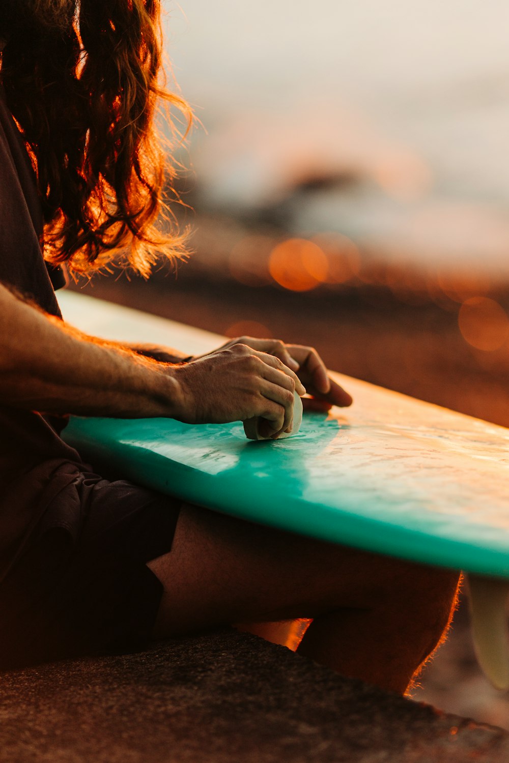 a man sitting on a bench holding a surfboard