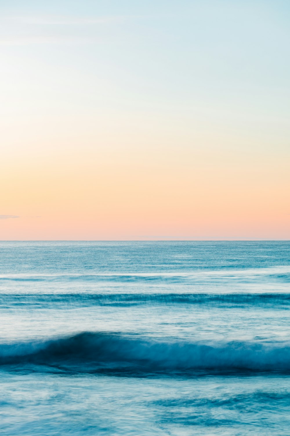 a person riding a surfboard on a wave in the ocean