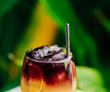 a drink with a straw in it sitting on a table