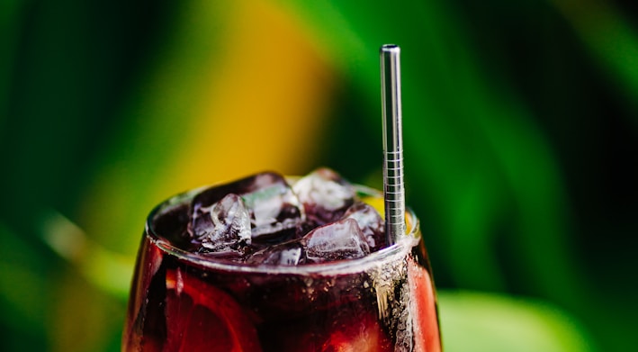 a drink with a straw in it sitting on a table