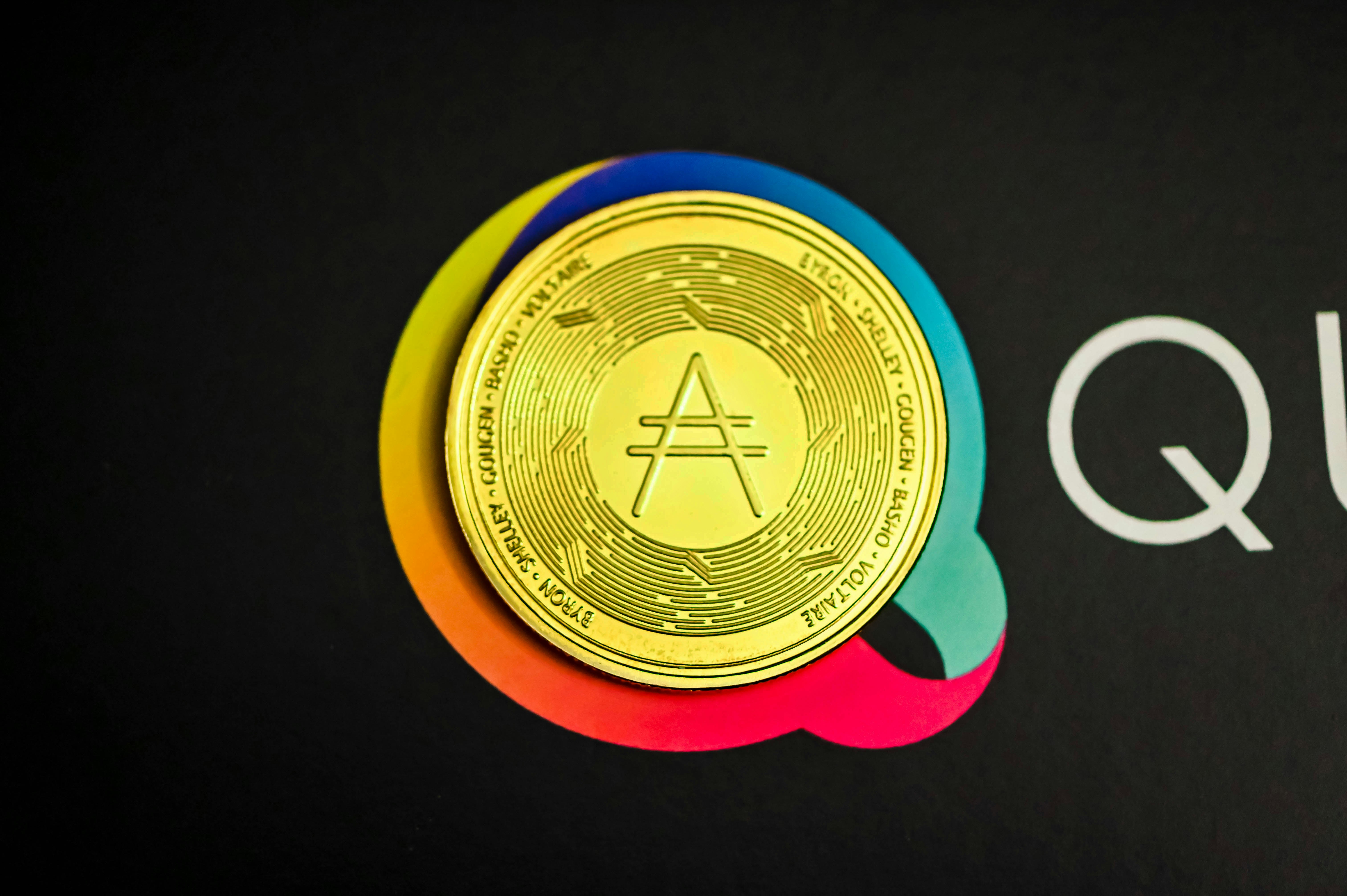 a close up of a gold coin on a black background