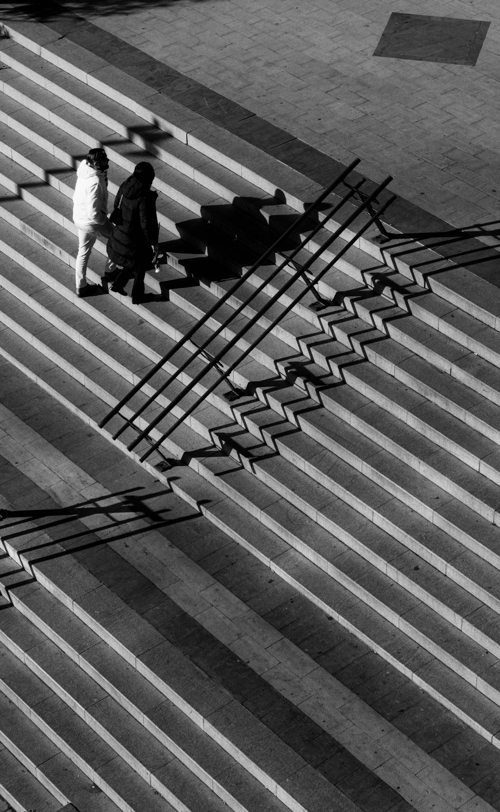 a couple of people that are walking down some stairs