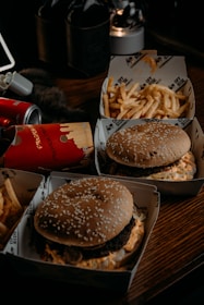 a table with two boxes of food and a can of soda