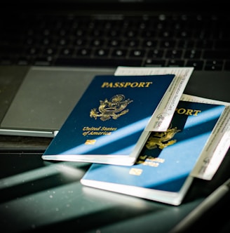 a passport sitting on top of a computer keyboard