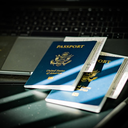 a passport sitting on top of a computer keyboard