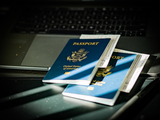 a passport sitting on top of a computer keyboard