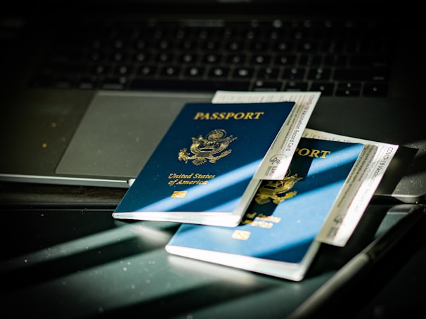 a passport sitting on top of a computer keyboard