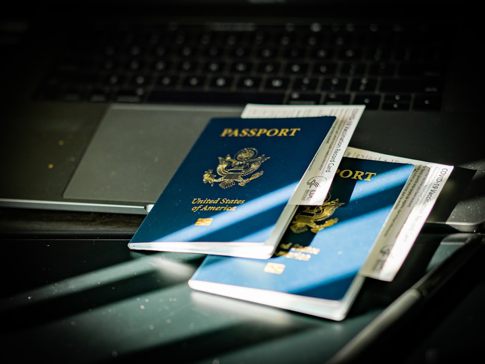 a passport sitting on top of a computer keyboard