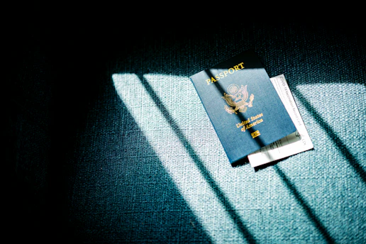 a blue passport sitting on top of a blue couch