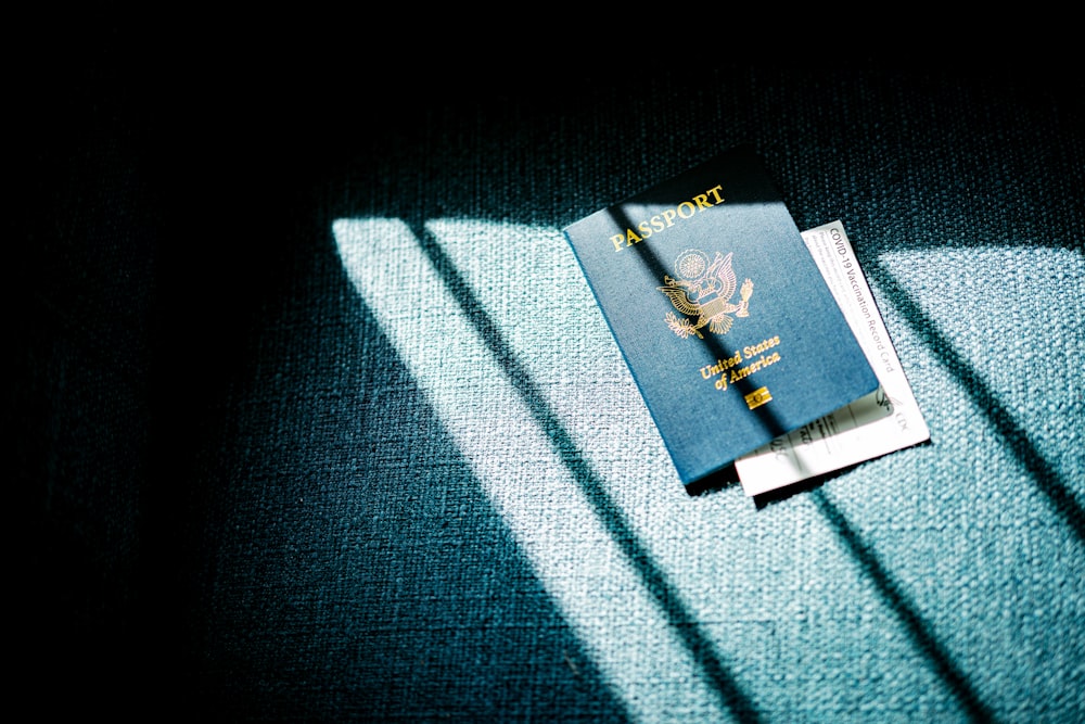 a blue passport sitting on top of a blue couch