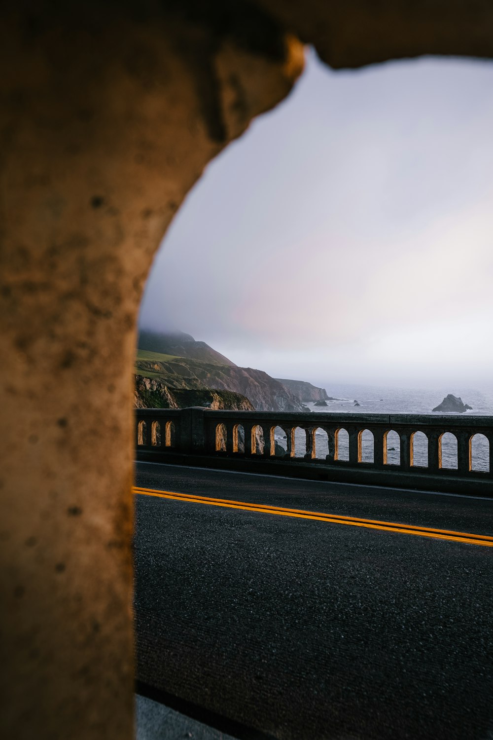 a view of the ocean through a hole in a wall