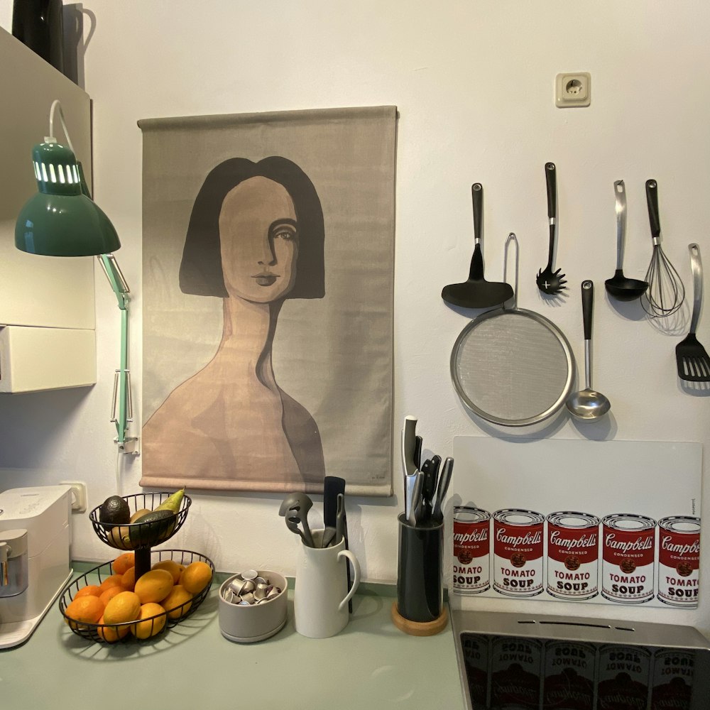 a picture of a woman on a wall above a kitchen counter