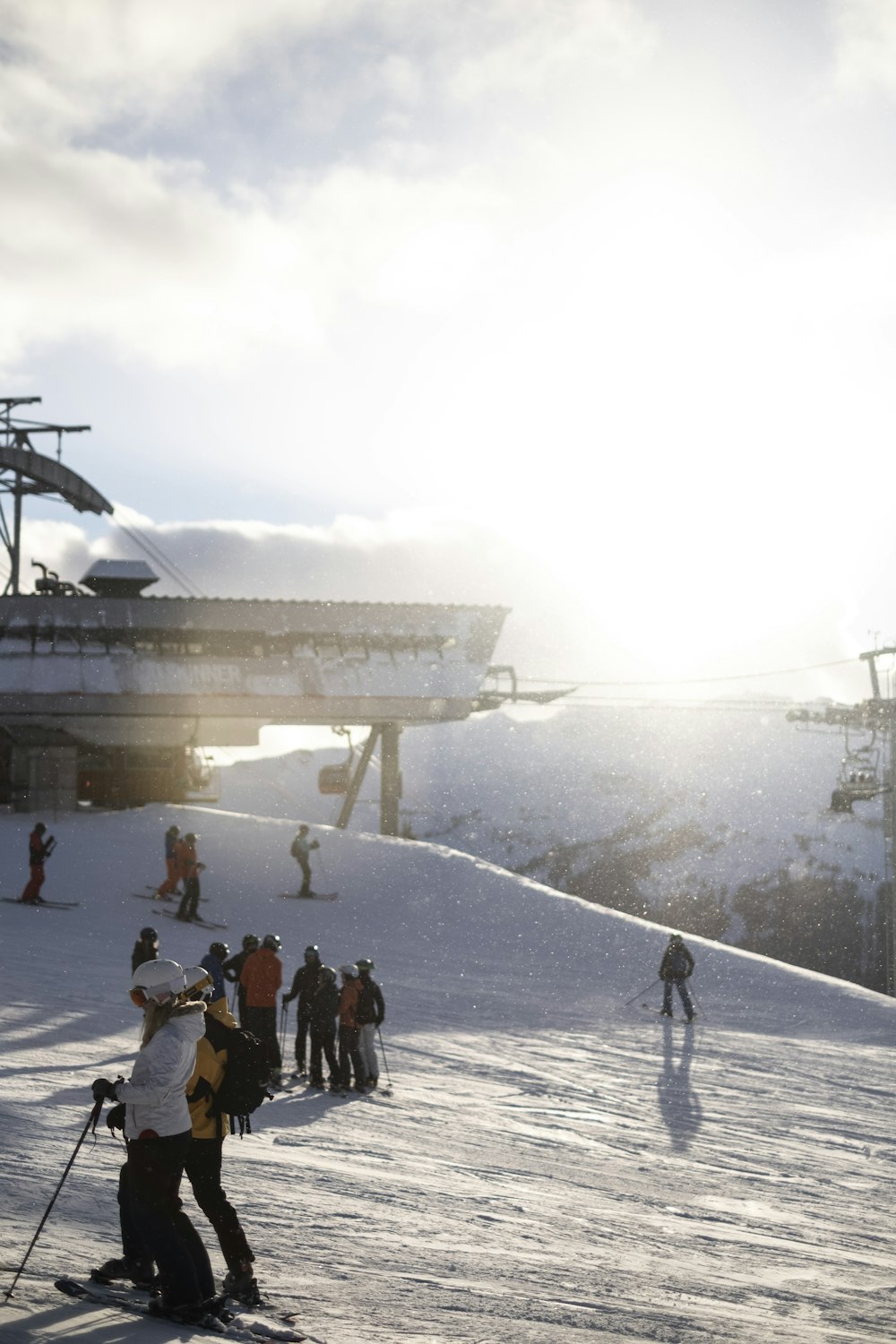 a group of people riding skis down a snow covered slope