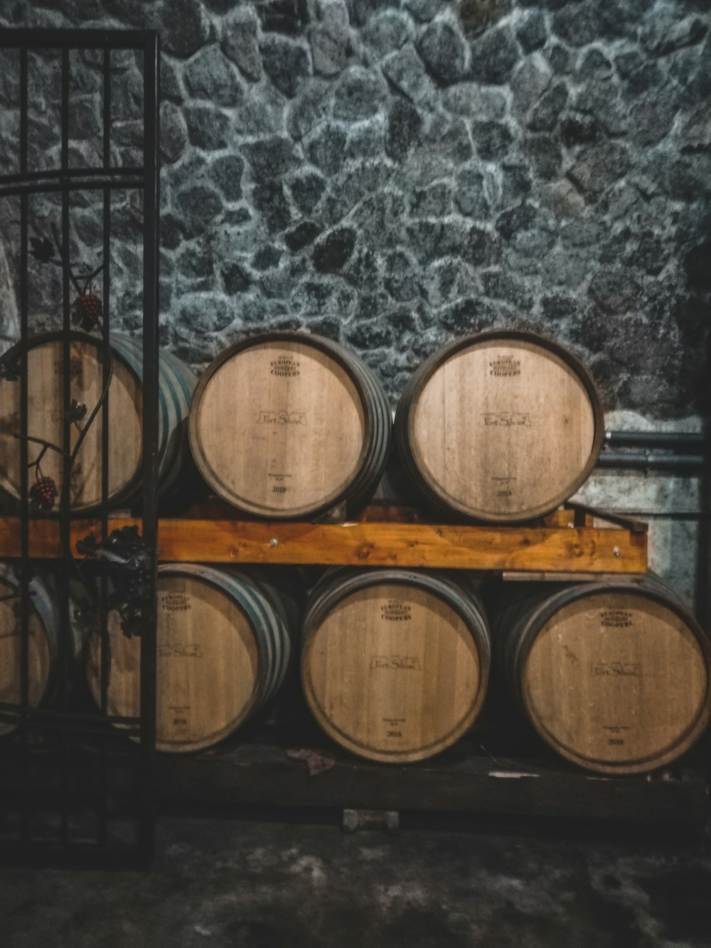 a bunch of barrels are stacked on a shelf