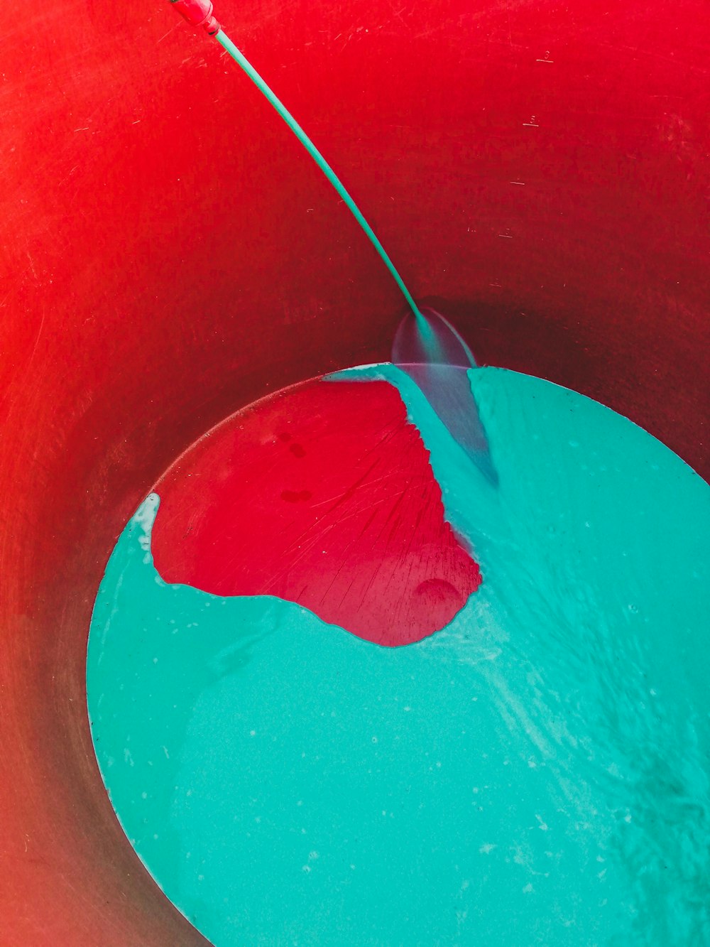 a red and blue bucket filled with water