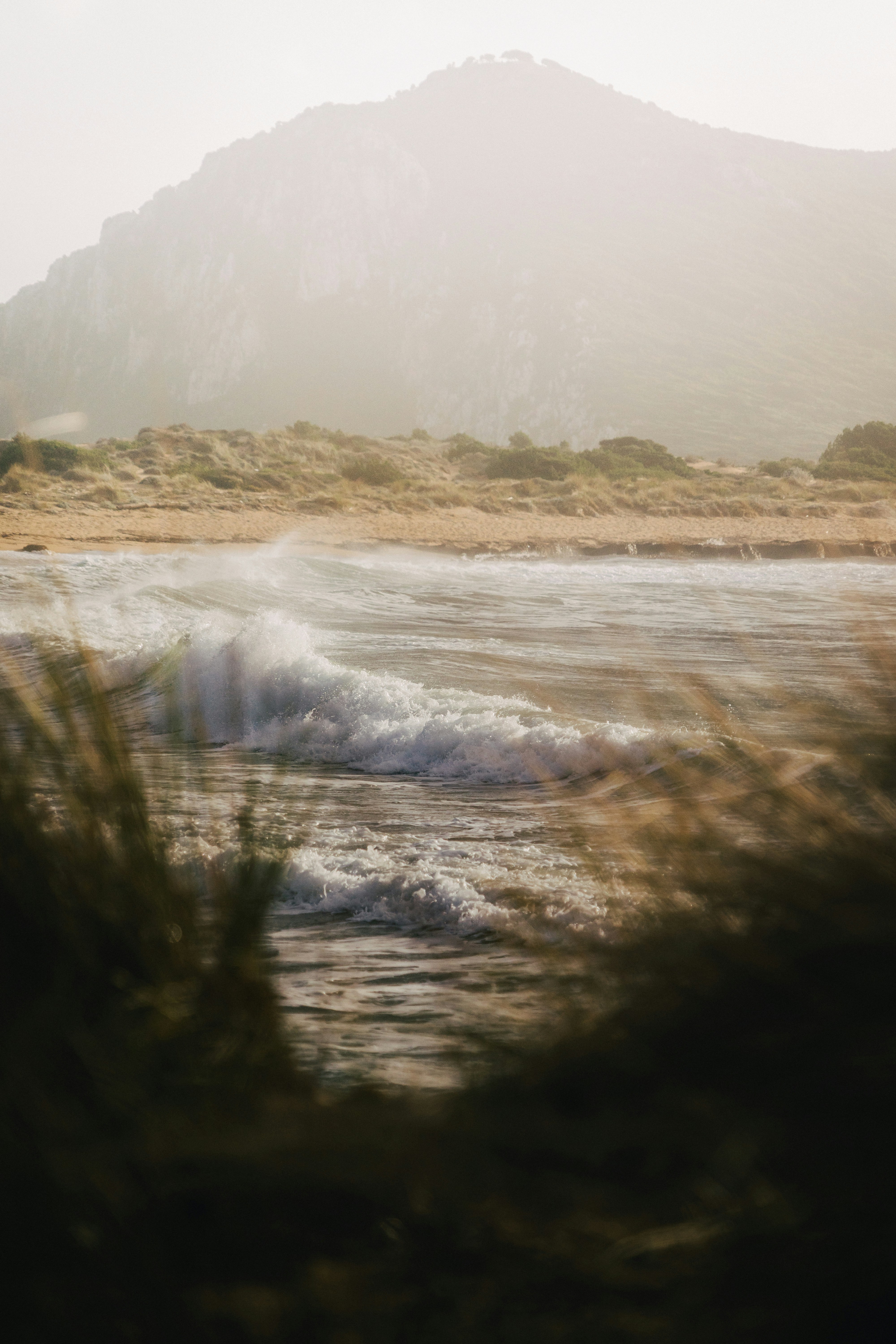 a body of water with a mountain in the background