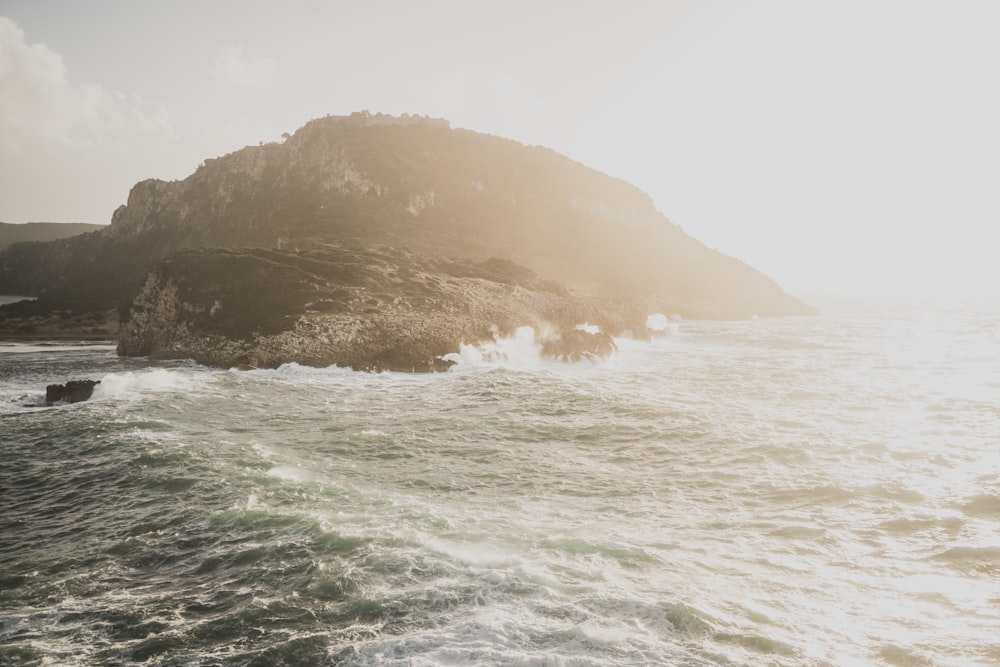 a rock outcropping in the middle of the ocean