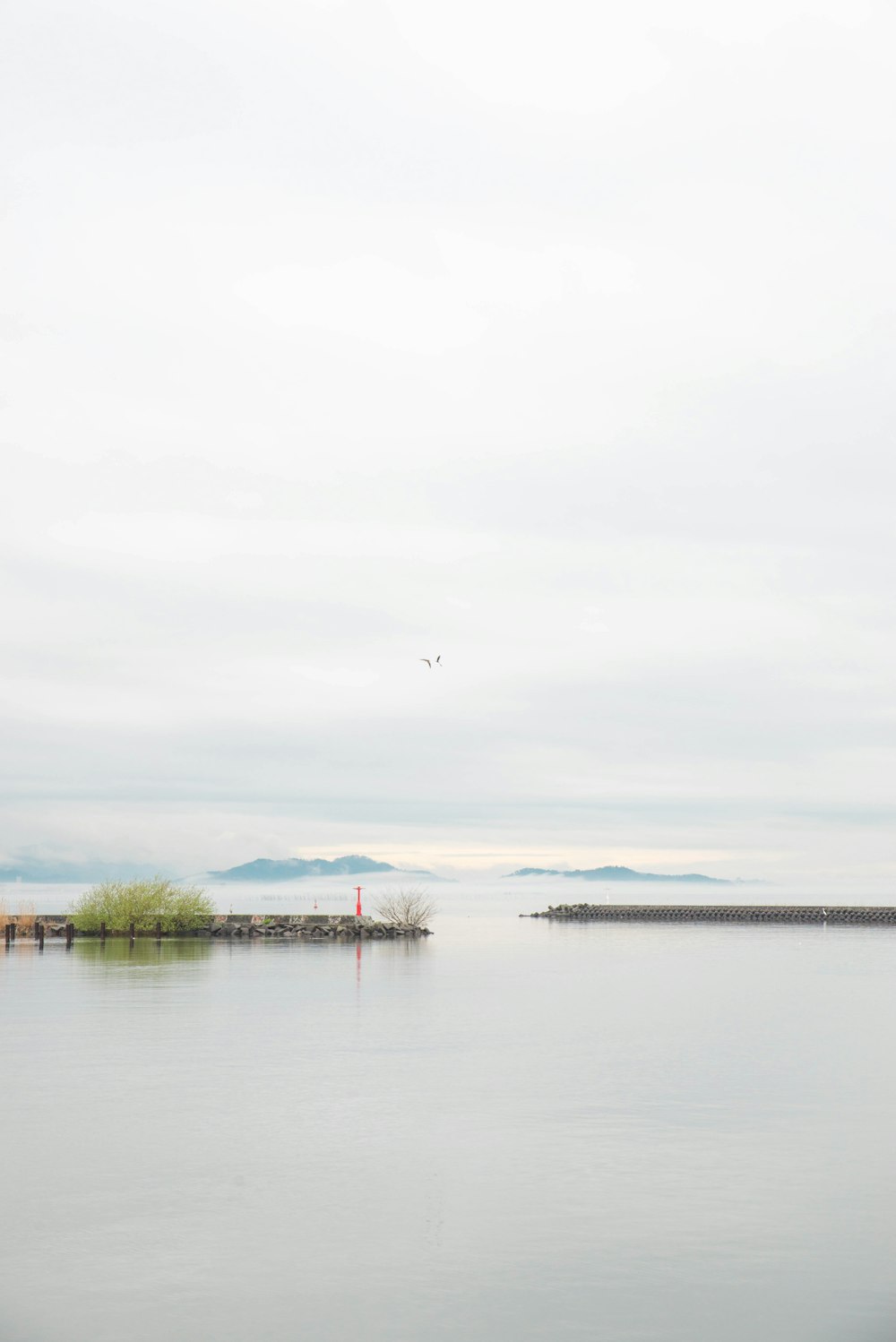 a body of water with a small island in the middle of it