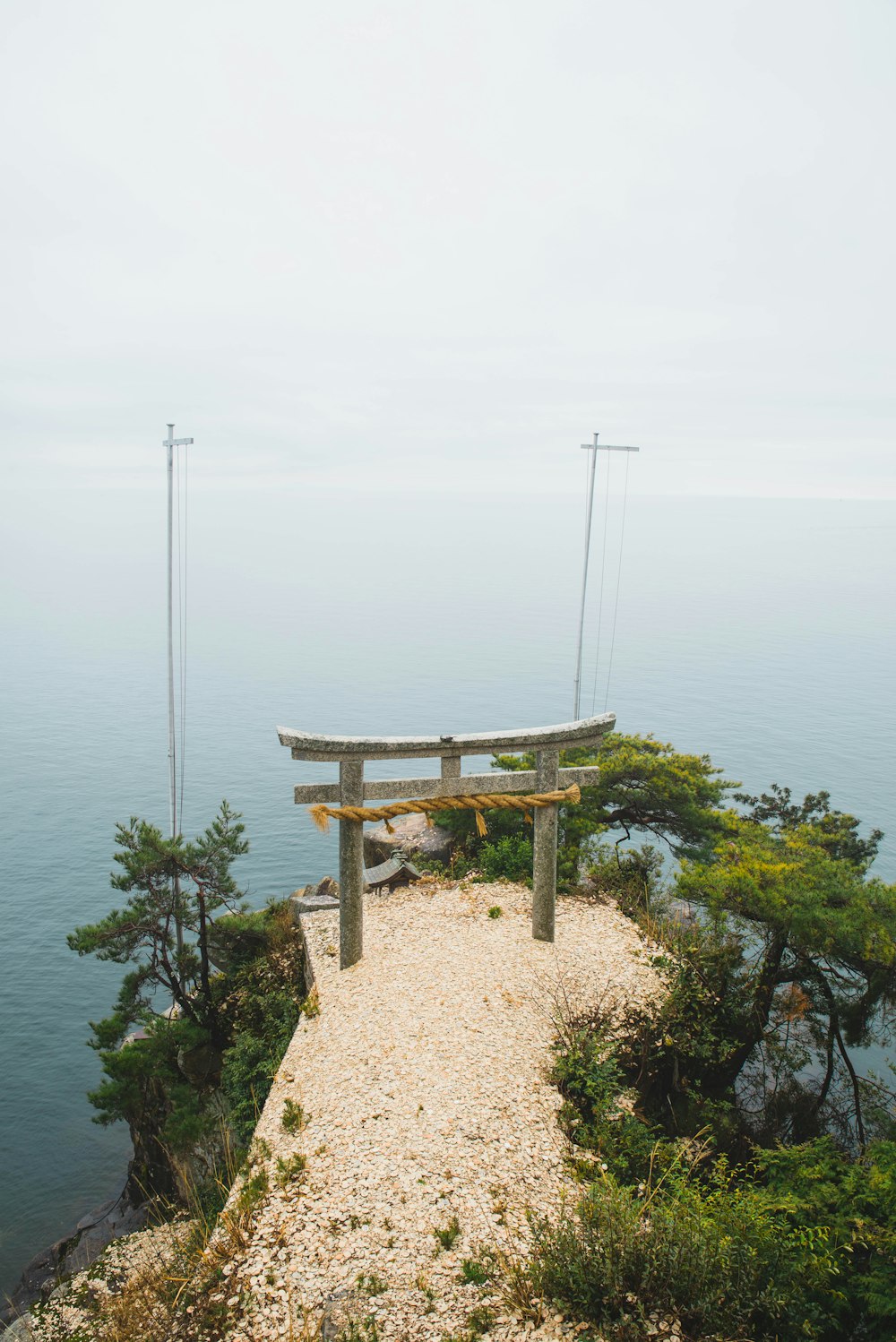 a bench sitting on top of a cliff near the ocean