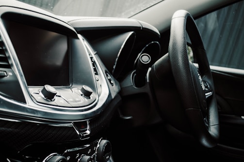 Close-up of a car dashboard featuring modern controls and a touchscreen display.