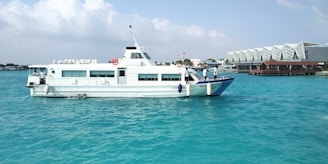 a large white boat floating on top of a body of water