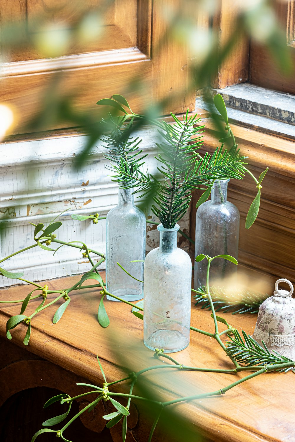 a wooden table topped with vases filled with plants