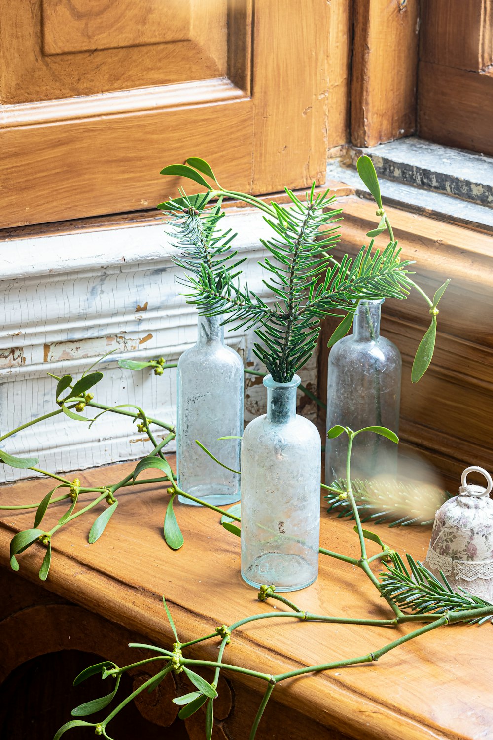 a wooden table topped with vases filled with plants