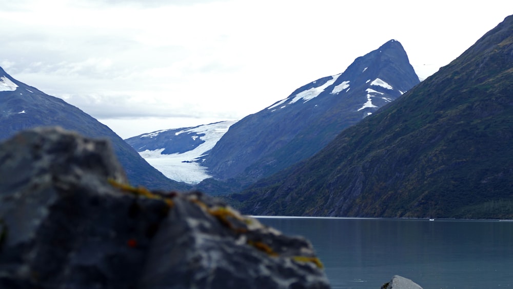 a mountain range with a body of water in the foreground