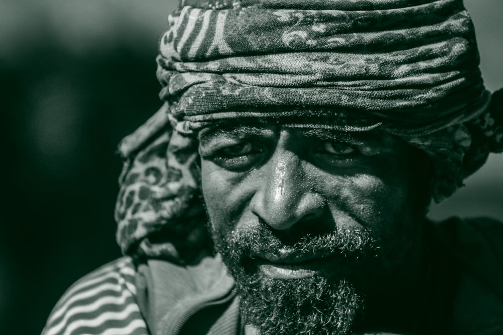 a black and white photo of a man wearing a turban