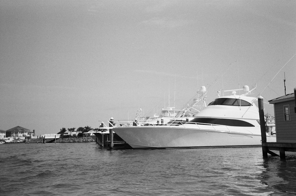 a large white boat docked at a pier